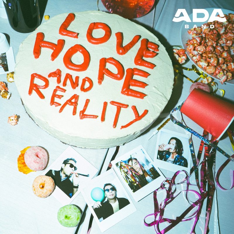 Love, Hope and Reality album cover: a cake with red icing lettering and polaroids of the band